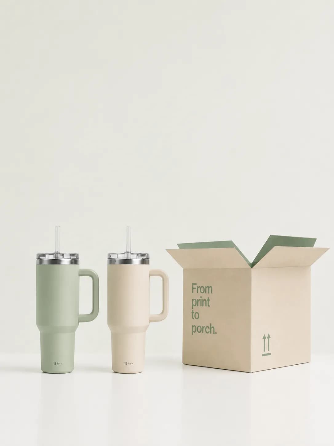 Two custom tumblers beside a labeled shipping box for print-on-demand fulfillment