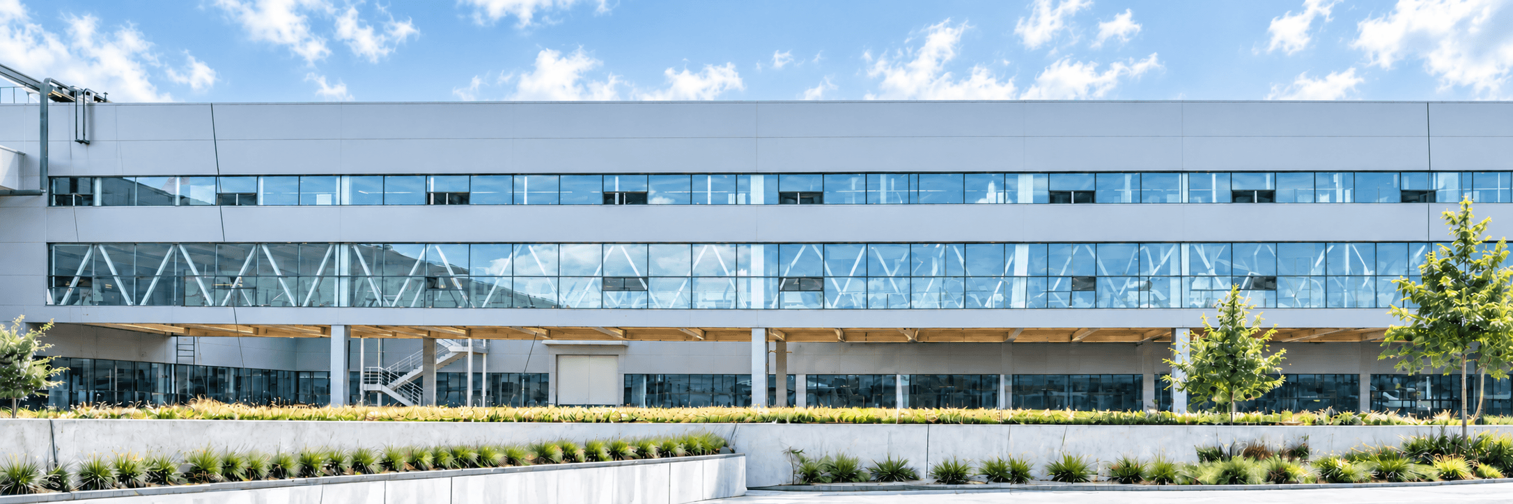 PYD Life manufacturing campus beneath a blue sky